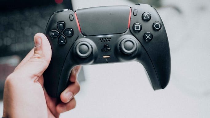 Holding Sony PlayStation 5 DualSense Wireless Controller